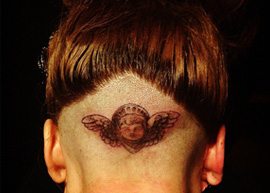 Lady Gaga tatua a cabeça durante lançamento de perfume