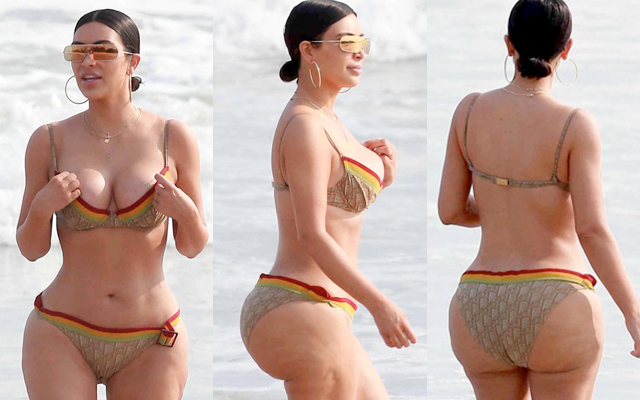 Kim Kardashian caminha de biquini na praia e celulites são notadas