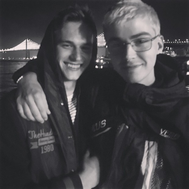 atores Brandon Flynn e Miles Heizer abraçados, em preto e branco