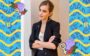 Emma Watson de braços cruzados e terno preto